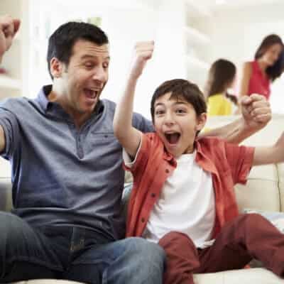 Excited Dad And Son In Living Room